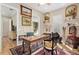 View of the home office with desk, hardwood floors and equestrian-themed art at 3690 Nw 56Th Ave, Ocala, FL 34482