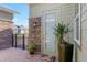 Close-up of the side door on a tile patio with stone accents and manicured landscaping at 3690 Nw 56Th Ave, Ocala, FL 34482