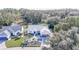 An aerial view showcasing a single-story house with a neatly landscaped front yard at 3923 Manor Oaks Ct, Leesburg, FL 34748