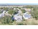 Aerial view showing a house with a screened patio and surrounding neighborhood at 3923 Manor Oaks Ct, Leesburg, FL 34748