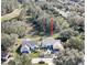 Aerial view of a house with a landscaped yard and golf course nearby at 3923 Manor Oaks Ct, Leesburg, FL 34748