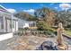 Charming backyard with a stone patio and a decorative statue at 3923 Manor Oaks Ct, Leesburg, FL 34748