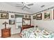 Guest bedroom with a bird-themed comforter and ceiling fan at 3923 Manor Oaks Ct, Leesburg, FL 34748