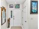 Bright entryway with white door and mirror at 3923 Manor Oaks Ct, Leesburg, FL 34748