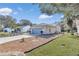 House exterior showcasing a gray garage door, landscaping, and driveway at 3923 Manor Oaks Ct, Leesburg, FL 34748