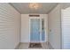Inviting front door with sidelight and covered entrance, creating a warm and welcoming ambiance at 3923 Manor Oaks Ct, Leesburg, FL 34748