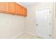 Laundry room with wooden cabinets and tile flooring at 3923 Manor Oaks Ct, Leesburg, FL 34748