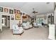 Spacious living room with many windows, fan, and comfortable seating, ideal for relaxation at 3923 Manor Oaks Ct, Leesburg, FL 34748