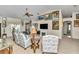 The open living room has a ceiling fan, a fireplace, and lots of art at 3923 Manor Oaks Ct, Leesburg, FL 34748