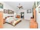 Spacious main bedroom with a ceiling fan, ensuite bathroom, and natural light at 3923 Manor Oaks Ct, Leesburg, FL 34748