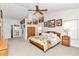 Spacious main bedroom with floral bedding and ceiling fan at 3923 Manor Oaks Ct, Leesburg, FL 34748