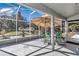 Enjoy this screened patio with comfortable seating, ceiling fan and umbrella at 3923 Manor Oaks Ct, Leesburg, FL 34748