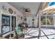 Relaxing screened patio with ceiling fan and outdoor dining area at 3923 Manor Oaks Ct, Leesburg, FL 34748