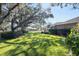 Large backyard with grass, shade trees, and privacy hedges at 4048 Se 38Th Loop, Ocala, FL 34480