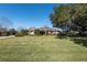 Spacious home with stone exterior, manicured lawn, and mature trees at 4048 Se 38Th Loop, Ocala, FL 34480