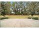 Large backyard with grassy area and trees at 5409 Sw 42Nd Pl, Ocala, FL 34474