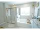 Bright bathroom with walk-in shower and soaking tub at 5429 Sw 44Th Court Rd, Ocala, FL 34474