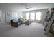 Bonus room with sectional sofa, ottoman, and ceiling fan at 5429 Sw 44Th Court Rd, Ocala, FL 34474