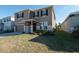 Two-story house with a neutral color palette, stone accents, and a two-car garage at 5429 Sw 44Th Court Rd, Ocala, FL 34474