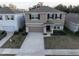 Two-story house with a neutral color palette, stone accents, and a two-car garage at 5429 Sw 44Th Court Rd, Ocala, FL 34474