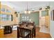 Kitchen dining area with hardwood floors and view into living room at 6760 Sw 112Th St, Ocala, FL 34476