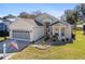 One-story house with a two-car garage and American flag at 6760 Sw 112Th St, Ocala, FL 34476