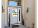 White front door with glass accents and welcoming mat at 6760 Sw 112Th St, Ocala, FL 34476