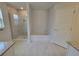 Bathroom featuring a glass-enclosed shower, a soaking tub, and modern tile work at 6915 Sw 152Nd St, Ocala, FL 34473