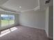 Well-lit bedroom with carpet and backyard view at 6915 Sw 152Nd St, Ocala, FL 34473