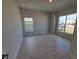 Bright bedroom with tile flooring, large windows, and neutral wall colors at 6915 Sw 152Nd St, Ocala, FL 34473