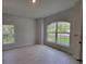 Bright bedroom featuring tile flooring, base trim and ample natural light from two windows at 6915 Sw 152Nd St, Ocala, FL 34473