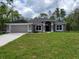 Charming single-story home featuring a well-manicured lawn and a two-car garage at 6915 Sw 152Nd St, Ocala, FL 34473