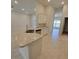 Kitchen island featuring light, granite countertops and stainless steel sink at 6915 Sw 152Nd St, Ocala, FL 34473