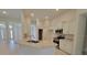 Open kitchen with granite counters, stainless appliances, and bright, white cabinets at 6915 Sw 152Nd St, Ocala, FL 34473