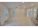 Large open-concept living room with high ceilings and light-colored tile floors at 6915 Sw 152Nd St, Ocala, FL 34473