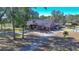 House with a long driveway and mature trees at 700 Se 49Th Ave, Ocala, FL 34471