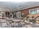 Covered patio with dining table and seating, adjacent to the house at 700 Se 49Th Ave, Ocala, FL 34471