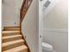 Upstairs hallway with carpeted stairs and a small, updated half-bath at 700 Se 49Th Ave, Ocala, FL 34471