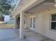 Covered patio with French doors, string lights, and ceiling fan at 7375 Sw 106Th St, Ocala, FL 34476