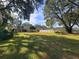 Large backyard with home, grassy area, and trees at 7375 Sw 106Th St, Ocala, FL 34476