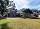 Large backyard with home, grassy area, and trees at 7375 Sw 106Th St, Ocala, FL 34476