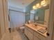 Bathroom with single vanity, shower/tub combo and tile floors at 7375 Sw 106Th St, Ocala, FL 34476