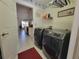 Laundry room with washer, dryer, and view into kitchen at 7375 Sw 106Th St, Ocala, FL 34476