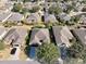 An aerial view showcases the neighborhood's well-maintained homes with lush landscaping and mature trees at 7387 Sw 99Th Ct, Ocala, FL 34481