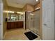 Bathroom featuring double sinks, a tile floor, neutral colored walls and a glass-enclosed shower at 7387 Sw 99Th Ct, Ocala, FL 34481