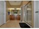 Bathroom featuring double sinks, a tile floor, neutral colored walls and a glass-enclosed shower at 7387 Sw 99Th Ct, Ocala, FL 34481