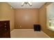 Bedroom with tan walls, carpet, and a window with blinds that provide soft, natural lighting at 7387 Sw 99Th Ct, Ocala, FL 34481