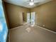 Bedroom featuring carpet, window and mirrored closet doors reflecting natural light, and a ceiling fan at 7387 Sw 99Th Ct, Ocala, FL 34481