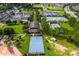 Overhead perspective of community basketball and tennis courts surrounded by green spaces at 7387 Sw 99Th Ct, Ocala, FL 34481