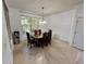 Dining room featuring a large window and a modern light fixture at 7387 Sw 99Th Ct, Ocala, FL 34481